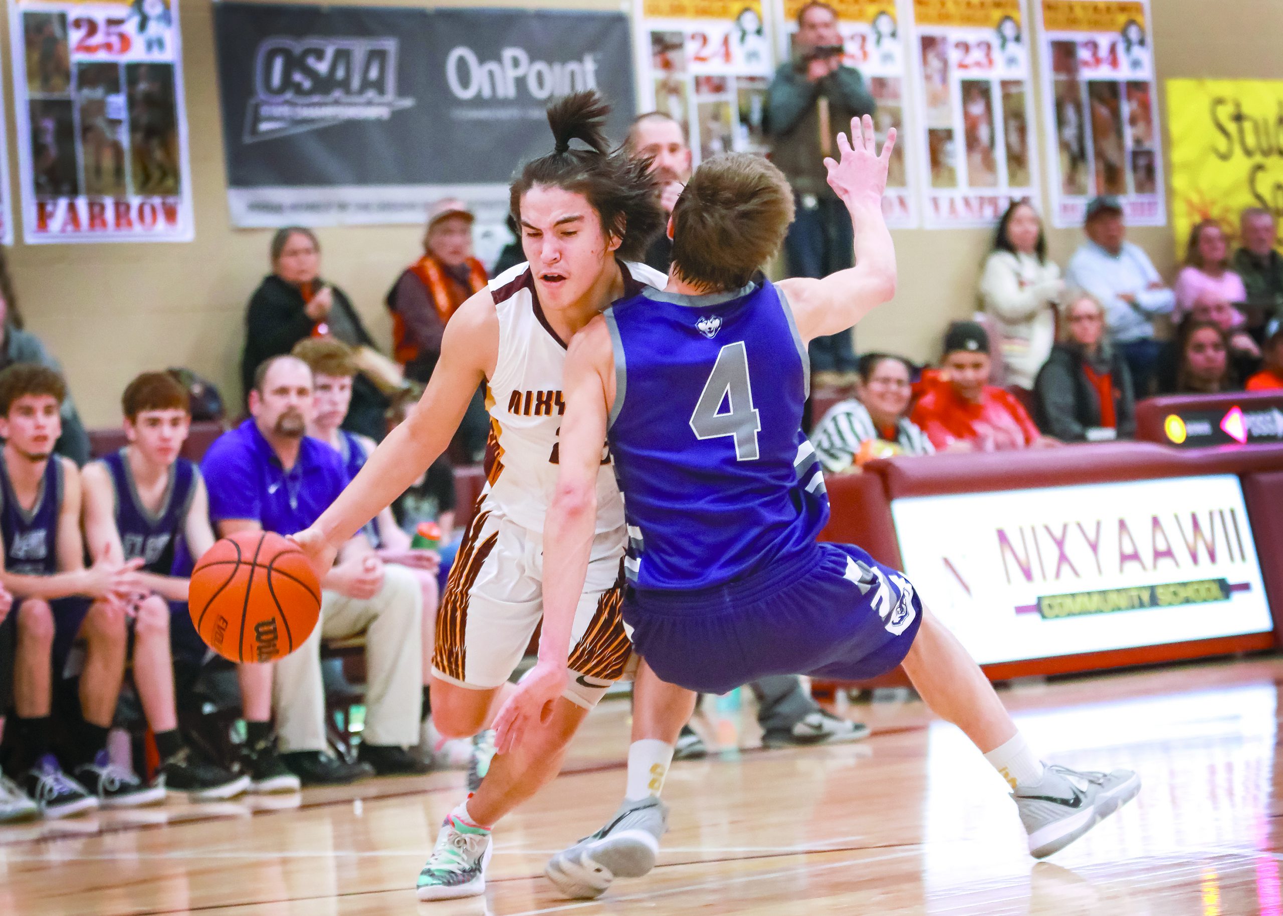 Tyasin Burns, who was named Player of the Year in the Old Oregon League, posterizes Elgin’s Tristan Simpson in the first half of Nixyaawii’s 69-38 would-be victory Feb. 14. However, the Golden Eagles had to forfeit the game. Read about it below. At left, Magi Moses posts up Joseph’s H. Miller at the Old Oregon League finals in Baker City.